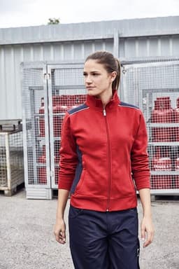 A red sweat jacket with contrasting navy accents, worn by a woman in a casual outdoor setting.