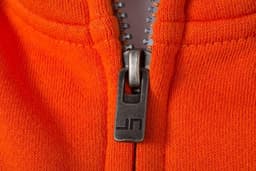 An orange zip hoodie featuring a metal zipper pull and a logo on the zip.