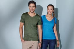 A green v-neck t-shirt worn by a man and a blue v-neck t-shirt worn by a woman, both smiling.
