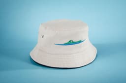 A white bucket hat featuring green and blue wave embroidery and a logo on the side.