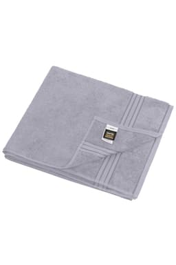 A grey sauna sheet folded neatly, featuring a textured surface and a small logo on the corner.