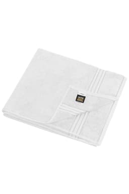 A white sauna sheet with a folded corner, featuring a small logo on the edge.
