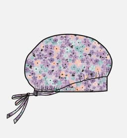 A printed unisex bouffant cap featuring a floral design in shades of purple, blue, and peach, with a tied ribbon.
