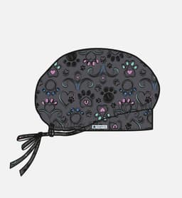 A printed unisex bouffant cap in grey featuring a colourful pattern of hearts and paw prints. It has a tie strap.