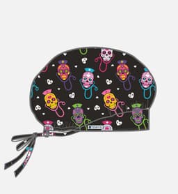 A printed unisex bouffant cap featuring a black background with vibrant sugar skull designs in various colours.