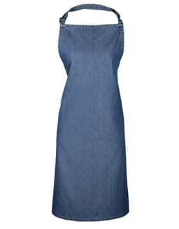 A denim bib apron in a solid blue colour, featuring an adjustable neck strap and a brand logo.