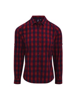 A check-patterned button-up shirt in red and navy, featuring long sleeves and a brand logo.