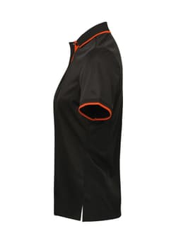 A women's polo shirt featuring a black body with orange contrast details and a modern cut. It has a logo displayed.