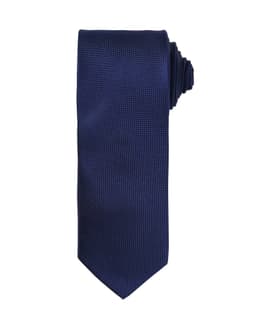 A navy blue micro waffle tie with a textured pattern and a rolled end. It features a logo.