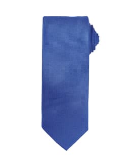 A blue micro waffle tie featuring a textured pattern and a pointed end. The tie has branding visible.