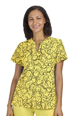 A vibrant yellow top featuring a playful pattern of smiles and abstract shapes, with a simple neckline.