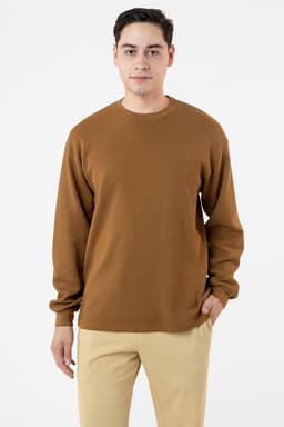 A brown heavy thermal crewneck sweater worn by a model, featuring a relaxed fit and long sleeves.