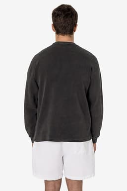 A man wearing a grey garment dye heavy thermal crewneck, viewed from the back, paired with white shorts.
