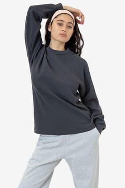A model poses in a dark grey heavy thermal crewneck jumper paired with light grey pants.