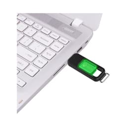 A flash drive in black and green connected to a laptop's USB port, featuring a logo.