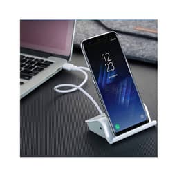 A white Media Hub Stand with a smartphone propped up, connected to a laptop via a USB cable.