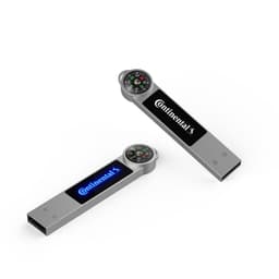 A silver LED flash drive featuring a compass on top and a logo, with blue and white backlighting.
