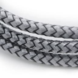 A close-up of a braided charging cable in grey and black, featuring a textured design and a logo.
