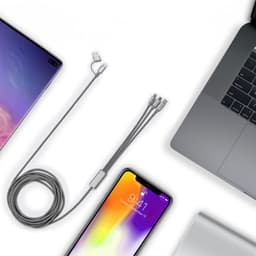 A grey charging cable with multiple connector types, alongside a smartphone and laptop on a white background.