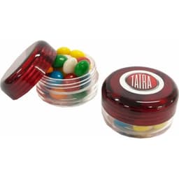 A small screw cap jar containing brightly coloured chewy fruit candies, with a red lid and a logo on top.
