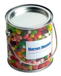 A big transparent PVC bucket filled with colourful jelly beans, featuring a metal lid and a handle.