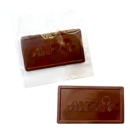 An embossed chocolate bar in dark brown, packaged in a clear wrapper, featuring a logo.