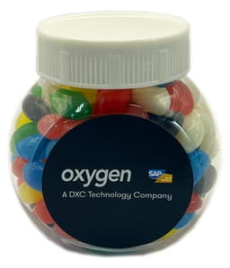 A plastic jar filled with colourful mini jelly beans, featuring a white lid and a logo on the front.