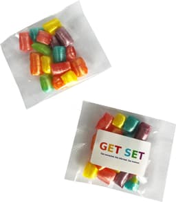 A packet of colourful humbugs in various shades, including pink, yellow, green, and blue, with packaging and branding.