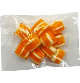 A clear bag containing orange and white striped humbug candies.