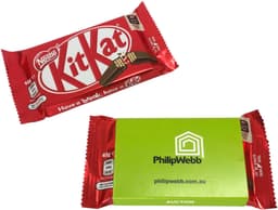 A red KitKat chocolate bar with a green sleeve packaging, featuring branding and product details.