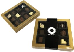 A boxed assortment of chocolates in a gold rimmed package, featuring various chocolate shapes and designs.