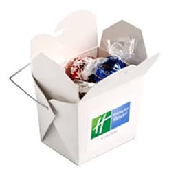 A white cardboard noodle box containing five Lindor Lindt balls, featuring a branding logo on the side.