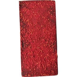 A block of chocolate-covered dried raspberries, featuring a vibrant red colour and textured surface.