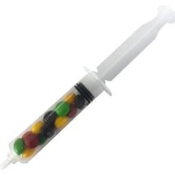 A syringe filled with colourful Skittles in yellow, green, black, red, and orange hues. Includes a branding logo.