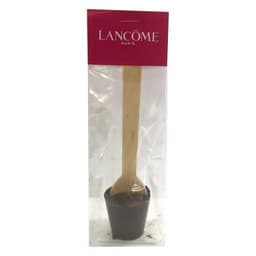 A chocolate spoon in a clear package, featuring a wooden handle and dark chocolate cup. It includes a branding logo.
