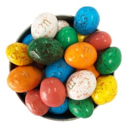 A bowl containing various chocolate eggs in colours like blue, green, red, yellow, and white, with some having speckled patterns.