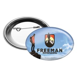 An oval button badge featuring a mountainous design with a figure, in blue, black, and white colours.
