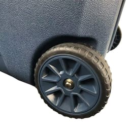A dark blue cooler box with textured surface and a sturdy wheel for easy transport.