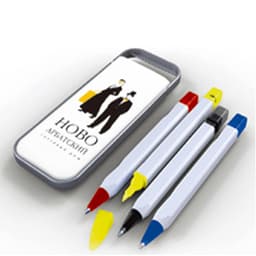 A pen set in a grey case featuring four pens: black, red, blue, and yellow, with a logo on the lid.