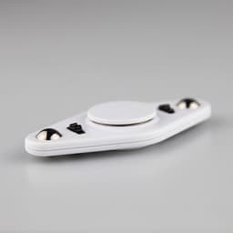 A white fidget spinner with a central circular area and black accents, featuring two smooth spinning balls.