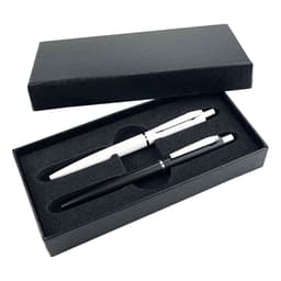 A black gift box containing a black metal pen and a white metal pen, both resting on a foam insert.