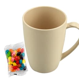 A bamboo mug in light beige next to a bag of colourful jelly beans, featuring a simple design and a handle.