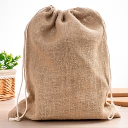 A natural beige jute bag with a drawstring closure, featuring a simple design and a logo.