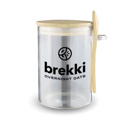 A clear overnight oats container with a wooden lid and spoon, featuring a logo on the side.