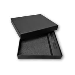 A black gift box containing a notebook and pen, lined with foam for protection.