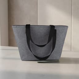 A grey lunch bag with black handles, featuring a spacious design and a sturdy build.