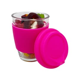 A pink reusable coffee cup holds a mix of jelly sweets, featuring a glass cup with a silicone sleeve.