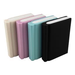Four book-shaped rubber erasers in cream, pink, teal, and black, featuring rounded edges and varying thicknesses.