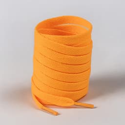 An orange roll of shoelaces stacked neatly, featuring a textured surface. The product has a logo on it.