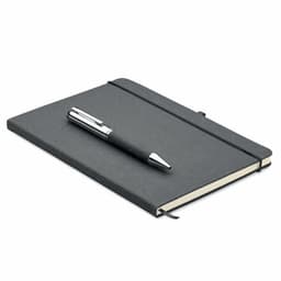 A black notebook with an elastic band and a silver pen resting on top. The notebook has a plain cover and blank pages.